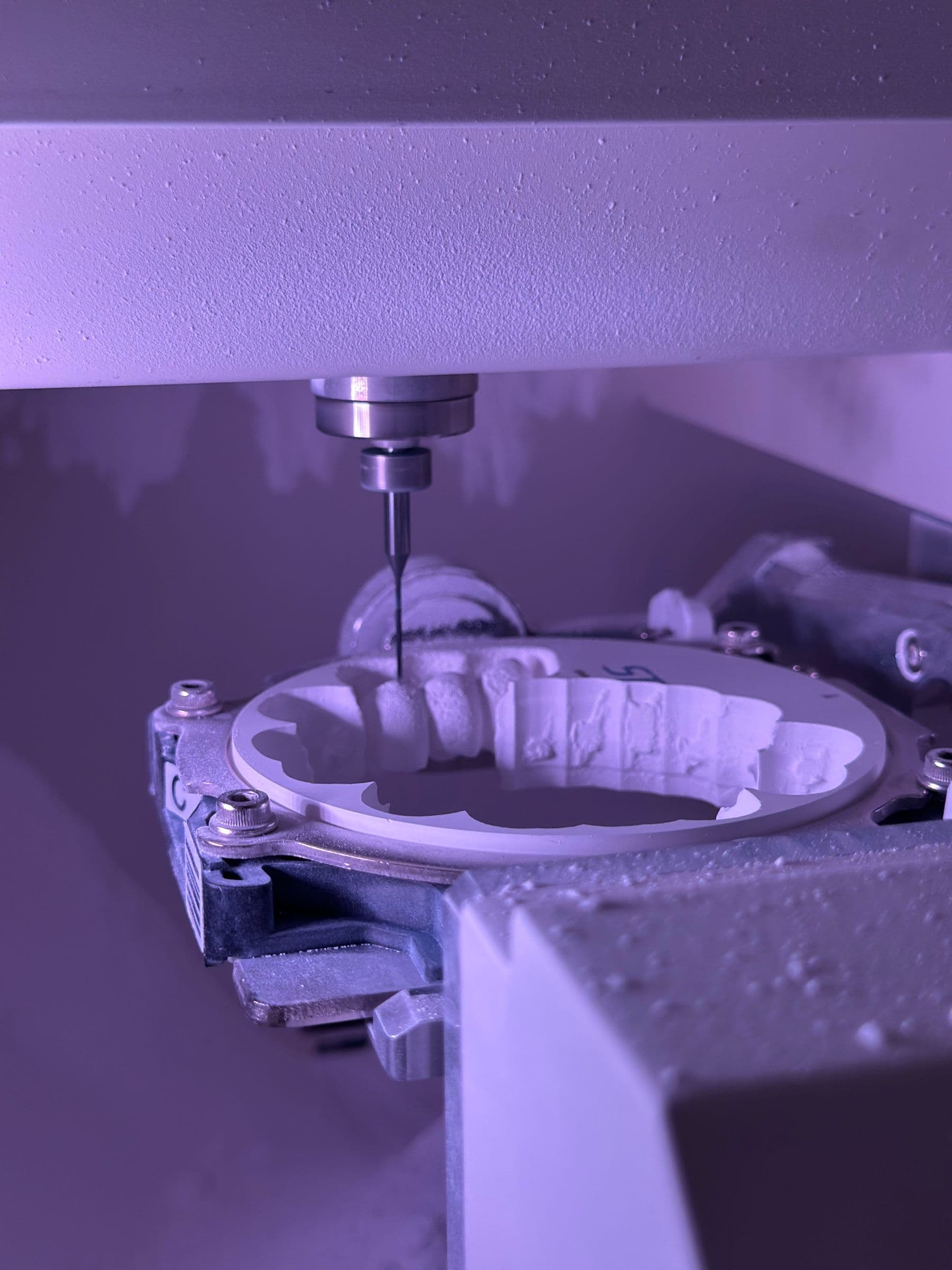 Precision dental CAD/CAM milling machine milling a denture restoration